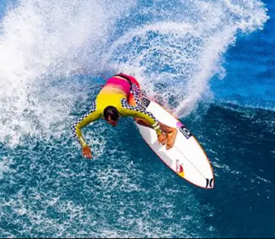 An overhead view of Julian surfing a wave. 